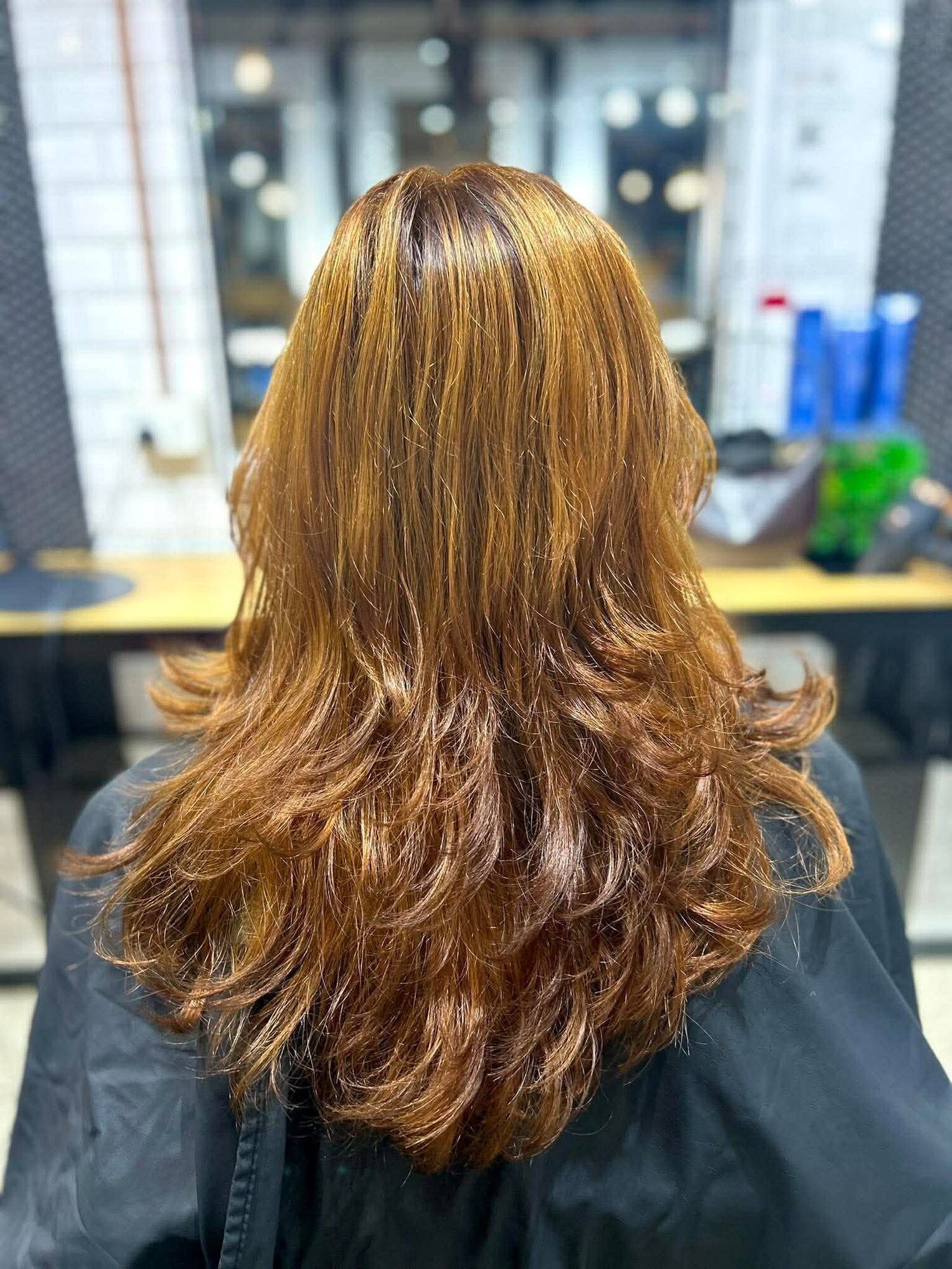 Golden layered cut at Hair Station