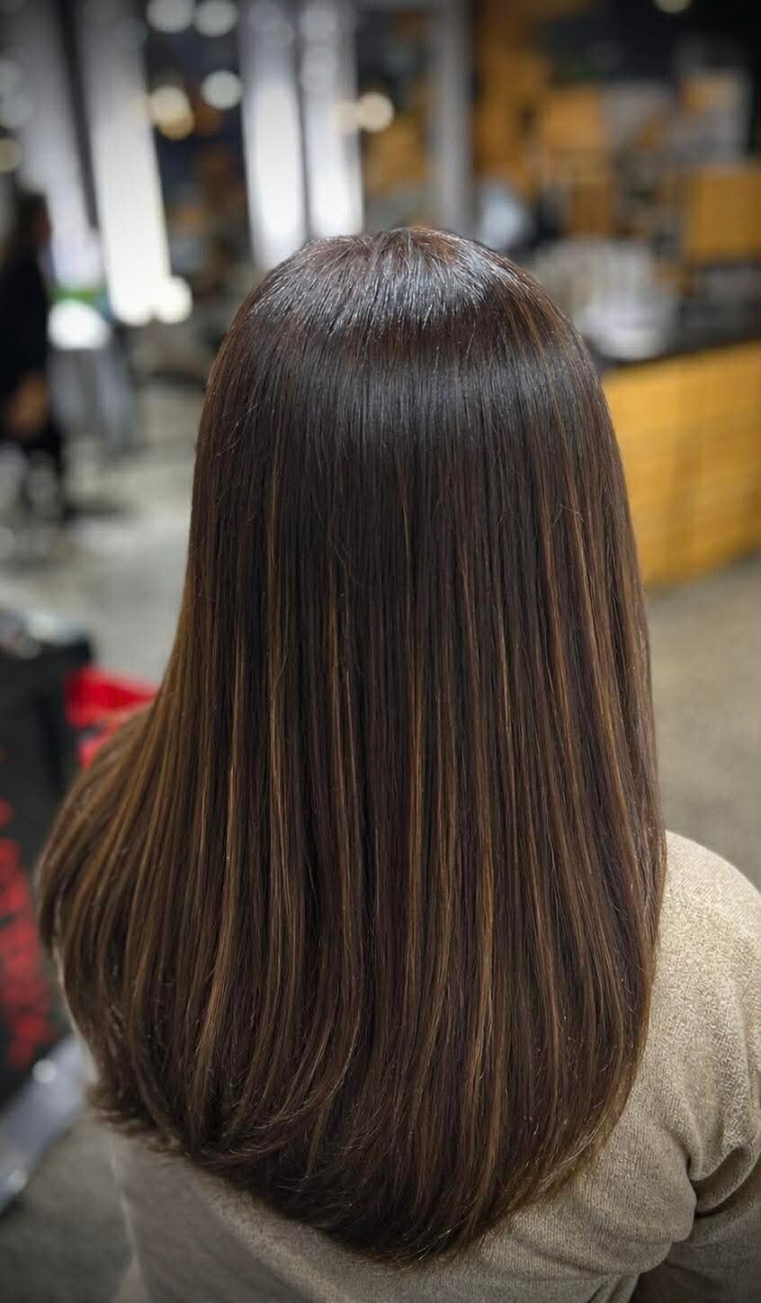 Glossy brunette blow-dry finished at Hair Station